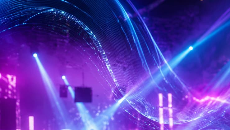 A DJ set with cyan and violet light waves flowing over the crowd
